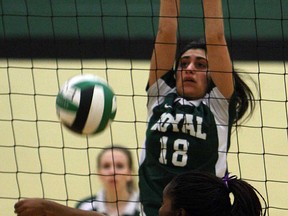 Chatham Christian High School's Sandy Hakiza tries to bump the ball past the block of Lajeunesse's Jillian Dzuggan during the SWOSSAA girls A volleyball final in Windsor Monday, Feb. 25, 2013. The Lasers won 3-1. (TYLER BROWNBRIDGE/The Windsor Star)