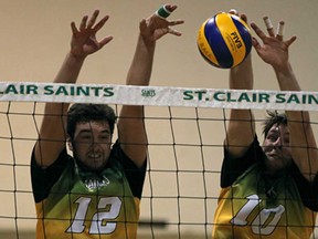 St. Clair's Curtis Lock, left, and Travis Wigle successfully block a spike against the Sheridan Bruins during OCAA men's Volleyball action at St. Clair College Sunday, February 10, 2013. THe Bruins beat the Saints 3-2. (DAX MELMER/The Windsor Star)