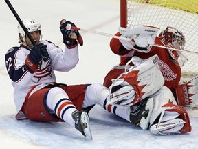 Blue Jackets centre Vinny Prospal, left, celebrates his goal on Wings goalie Jimmy Howard during the third period in Detroit, Thursday, Feb. 21, 2013. Columbus won 3-2. (AP Photo/Carlos Osorio)