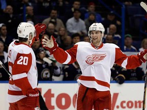 Detroit's Jakub Kindl, right, is congratulated by Drew Miller after scoring against the Blues Thursday, Feb. 7, 2013, in St. Louis. (AP Photo/Jeff Roberson)