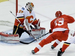 Calgary goalie Leland Irving, left, stops a shot by Detroit's Pavel Datsyuk during the third period in Detroit, Tuesday, Feb. 5, 2013. Calgary won 4-1. (AP Photo/Paul Sancya)