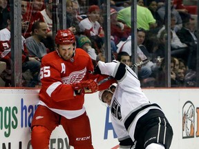 Red Wings defenseman Niklas Kronwall, left, checks Los Angeles left wing Simon Gagne during the first period in Detroit, Sunday, Feb. 10, 2013. (AP Photo/Carlos Osorio)