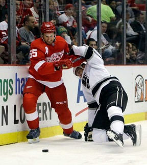 Red Wings defenseman Niklas Kronwall, left, checks Los Angeles left wing Simon Gagne during the first period in Detroit, Sunday, Feb. 10, 2013. (AP Photo/Carlos Osorio)