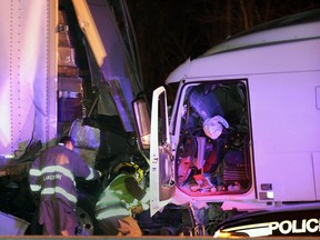 OPP and Lakeshore firefighters at the scene of a collision involving two tractor trailer rigs on eastbound Hwy. 401,  west of Belle River Road Monday March 4, 2013.  (NICK BRANCACCIO/The Windsor Star)