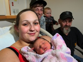 Mom Paige Dalgleish holds newborn daughter Bella Lynn, who was born with the assistance of her father Josh McGuire, behind left, and grandfather Dave Dalgleish, right.  Joining the group is Christopher McGuire, 17 months old, son of Josh and Paige, at Windsor Regional Hospital's Met Campus Tuesday March 5, 2013. (NICK BRANCACCIO/The Windsor Star)