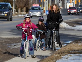 Nicole Bentley, left, with her children Jaidyn, 8, front, Amber, 7, and Ryan, 4, behind, along Cabana Road East Tuesday March 5, 2013.  Bentley and her neighbours are overjoyed the city has approved $1.8 million for a 5.5 km recreational trail linking her area with Hon. Herb Gray Parkway to the west.  (NICK BRANCACCIO/The Windsor Star)