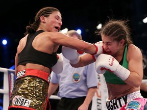 U.S. flyweight boxer Melissa McMorrow, right, and German challenger Nadia Raoui exchange punches during the WBO and WIBF World Championship Female Flyweight title fight on Saturday, March 23, 2013 at the Getec-Arena in Magdeburg, Germany. (AFP PHOTO/RONNY HARTMANN)