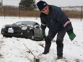 Sam Anbar, from Abrams Towing Services, prepares to tow a vehicle out of the ditch on the E.C. Row Expressway west of the Lauzon Parkway westbound on-ramp, Saturday, March 16, 2013.  (DAX MELMER/The Windsor Star)