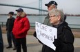 Protesters in Windsor demonstrate against petcoke piles across the Detroit River in this March 9, 2013 file photo.