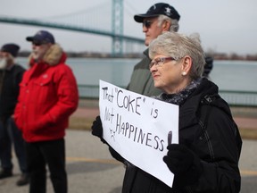 Protesters in Windsor demonstrate against petcoke piles across the Detroit River in this March 9, 2013 file photo.