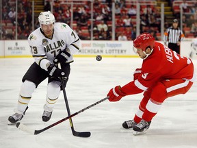 Michael Ryder, right, of the Dallas Stars battles for the puck with Kent Huskins of the Detroit Red Wings during the second period at Joe Louis Arena on Jan. 22, 2013. Huskins was traded to the Philadelphia Flyers on Saturday, March 30, 2013.(Gregory Shamus/Getty Images)