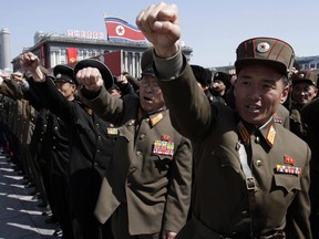 North Korean army officers punch the air as they chant slogans during a recent rally at Kim Il Sung Square in downtown Pyongyang, North Korea, in support of their leader Kim Jong Un's call to arms. (AP Photo/Jon Chol Jin)
