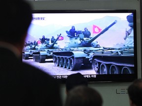 People watch a news report showing North Korean army tanks, at Seoul Railway Station in Seoul, South Korea, Saturday, March 30, 2013. North Korea warned Seoul on Saturday that the Korean Peninsula was entering "a state of war" and threatened to shut down a factory complex that's the last major symbol of inter-Korean co-operation. (AP Photo/Ahn Young-joon)