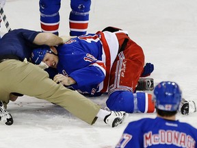 New York Rangers' Marc Staal is helped by a trainer after being injured during the third period of an NHL hockey game against the Philadelphia Flyers on Tuesday, March 5, 2013, in New York. (AP Photo/Frank Franklin II)