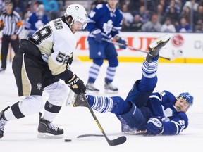 Toronto's James van Riemsdyk, right, makes a play in front of Pittsburgh's Kris Letang in Toronto Saturday. (THE CANADIAN PRESS/Chris Young)