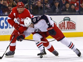 Detroit's Niklas Kronwall, left, is checked by Matt Calvert of the Blue Jackets Saturday at Nationwide Arena in Columbus, Ohio. (Photo by Kirk Irwin/Getty Images)