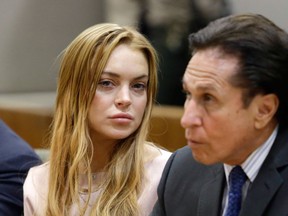 Actress Lindsay Lohan and attorney Mark Heller appear at a hearing in Los Angeles Superior Court on March 18, 2013 in Los Angeles. (Reed Saxonl/Getty Images)