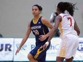 Lancers guard Miah-Marie Langlois, left, brings the ball up court against Calgary's Tamara Jarrett Saturday during a semifinal match at the CIS Women's Basketball Championship at the University of Regina. (Michael Bell/Leader-Post)