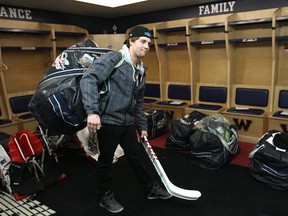 Windsor native Trevor Murphy carries his bag and hockey sticks at the WFCU Centre Monday. (DAX MELMER/The Windsor Star)
