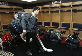 Windsor native Trevor Murphy carries his bag and hockey sticks at the WFCU Centre Monday. (DAX MELMER/The Windsor Star)