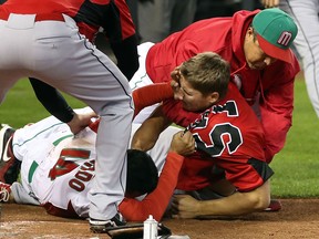 Eduardo Arredondo #14 of Mexico fights with Jay Johnson #57 of Canada during the World Baseball Classic First Round Group D game at Chase Field on March 9, 2013 in Phoenix, Arizona. Canada defeated Mexico 10-3. (Photo by Christian Petersen/Getty Images)