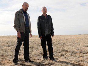 This file image released by AMC shows Bryan Cranston as Walter White, left, and Aaron Paul as Jesse Pinkman in a scene from the season 5 premiere of "Breaking Bad." As “Breaking Bad” finishes filming its fifth and final season in Albuquerque, the popularity of the show is providing a boost to the economy and creating a dilemma for local tourism officials as they walk the fine line of profiting from a show that centers around drug trafficking, addiction and violence. (AP Photo/AMC, Ursula Coyote)