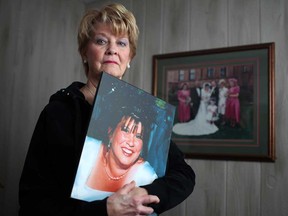 Elaine Douglas, 70, holds a portrait of her daughter, Wendy Douglas-Menard, standing next to her daughter's wedding photo, while at her home in LaSalle, Ont. Sunday, February 3, 2013.  Elaine's daughter died at the age of 34 on Dec. 14, 2003.  (DAX MELMER/The Windsor Star)