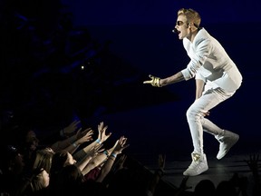 In a file picture taken on March 4, 2013 Canadian singer Justin Bieber performs live in concert at the O2 in London. Under-fire Canadian pop star Justin Bieber halted his London show for 20 minutes on March 7, 2013 after complaining of being "light of breath". Bieber, who angered fans after turning up nearly two hours late for the show on March 4 at the O2 Arena, returned to the stage to complete his set before being taken to hospital. AFP PHOTO / JUSTIN TALLIS