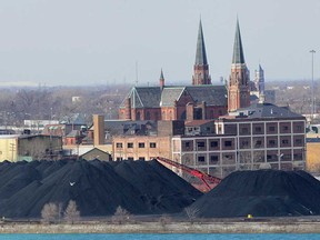 Huge piles of petroleum coke are offloaded  at the Transflo Terminal in Detroit on Mar. 8, 2013.  (DAN JANISSE/The Windsor Star)