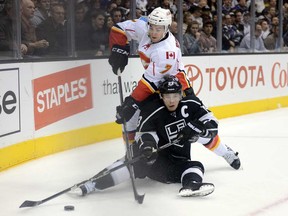 Dustin Brown #23 of the Los Angeles Kings makes a pass from the ice in front of T.J. Brodie #7 of the Calgary Flames during the second period at Staples Center on March 11, 2013 in Los Angelesa.  (Photo by Harry How/Getty Images)