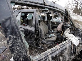 This Monday, March 11, 2013 photo in Southington, Ohio shows the vehicle where six people died in a crash early Sunday in Warren, Ohio. Two teens who escaped the crash that killed six friends in a swampy pond wriggled out of the wreckage by smashing a rear window and swimming away from the SUV, a state trooper said Monday. (AP Photo/Tony Dejak)