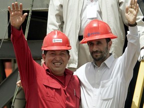 n this Sept. 18, 2006 file photo, Venezuela's President Hugo Chavez, left, and Iran's President Mahmoud Ahmadinejad wave to the press after inaugurating an oil drill in San Tome, Venezuela. Venezuela's Vice President Nicolas Maduro announced on Tuesday, March 5, 2013 that Chavez has died. Chavez, 58, was first diagnosed with cancer in June 2011. (AP Photo/Fernando Llano, File)