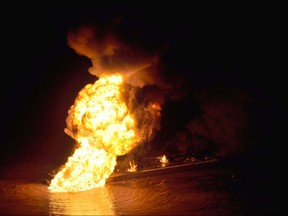 This US Coast Guard handout image shows a natural gas pipeline burning after a collision with the tugboat Shanon E. Setton near Bayou Perot 30 miles south of New Orleans, Louisiana March 12, 2012. The tug, loaded with crude oil struck a natural gas line, causing the fire, injuring at least two persons. The Coast Guard is working with federal, state and local agencies in response to this incident to ensure the safety of responders and contain and clean up any oil that is leaking. AFP PHOTO/HANDOUT / US Coast Guard Air Station New Orleans