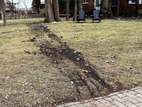 Tire tracks are all that remains of a van that ended up on the front lawn of  a home in the 2100 block of Niagara Street in Windsor, Ont. on Wednesday, March 13, 2013.                     (TYLER BROWNBRIDGE/The Windsor Star)