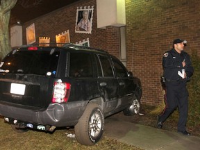 A Windsor Police officer investigates the scene of an accident Monday, March 18, 2013, at the Gino Marcus Community Centre on Drouillard Rd. in Windsor, Ont. The driver of this SUV was arrested at the scene for impaired driving. He sideswiped a car and narrowly missed people coming out of the building, according to witnesses. (DAN JANISSE/The Windsor Star)