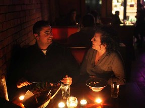 Files: Cal Stagno, left, and Amanda Malkowski enjoy a dinner in the dark while at Chanoso's and Oishii as the Windsor restaurant turned out the lights for Earth Hour, Saturday, March 23, 2013.  (DAX MELMER/The Windsor Star)
