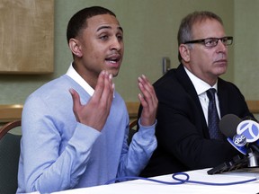 Sheldon Stephens, left, accompanied by his attorney Jeff Herman, addresses a news conference, in New York, Tuesday, March 19, 2013. Stephens, 24, of Harrisburg, Pa., has filed suit against Kevin Clash, former voice of the "Sesame Street" character Elmo, claiming the entertainer lured him into drug-fueled sex when he was 16. (AP Photo/Richard Drew)