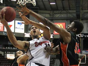Windsor's Kevin Loiselle, centre, drives to the basket while being defended by Oshawa's Shamus Ferguson as the Windsor Express host the Oshawa Power at the WFCU Centre in their final regular season game, Saturday, March 16, 2013.  (DAX MELMER/The Windsor Star)