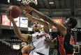 Windsor's Kevin Loiselle, centre, drives to the basket while being defended by Oshawa's Shamus Ferguson as the Windsor Express host the Oshawa Power at the WFCU Centre in their final regular season game, Saturday, March 16, 2013.  (DAX MELMER/The Windsor Star)