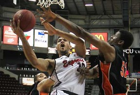 Windsor's Kevin Loiselle, centre, drives to the basket while being defended by Oshawa's Shamus Ferguson as the Windsor Express host the Oshawa Power at the WFCU Centre in their final regular season game, Saturday, March 16, 2013.  (DAX MELMER/The Windsor Star)