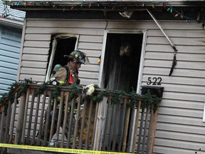 A firefighter with Windsor Fire and Rescue is at the scene of an early morning house fire at 522 Bridge Ave., Sunday, March 31, 2013.  (DAX MELMER/The Windsor Star)