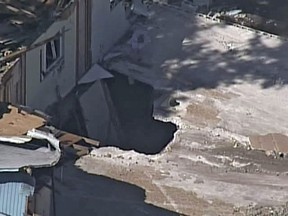 In this video image provided by ABC Action News-WFTS TV, shows an aerial photo of a sinkhole Monday, Mar. 4, 2013, in Seffner, Fla. The hole opened up underneath a bedroom late Thursday evening and swallowed Jeffrey Bush in Seffner, Fla. (AP Photo/ABC Action News-WFTS TV)