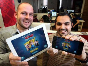 Jakub Koter, left, and Ali Al-Aasm of Red Piston, makers of apps and games in Windsor, Ont., show their recently developed Dave and Chuck the Freak's Kick-Ass game designed for Dave and Chuck The Freak radio personalities, March 6, 2013. (NICK BRANCACCIO/The Windsor Star)