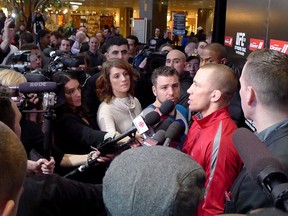 UFC welterweight Georges St-Pierre talks to reporters after a public workout at a downtown mall in advance of UFC 158 in Montreal on Wednesday, March 13, 2013. THE CANADIAN PRESS/Neil Davidson