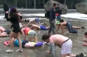 YouTube footage shows the newcomers in their underwear crawling through ice and slush on an outdoor university skating rink while organizers shout at them from the sidelines. Photograph by: Screengrab , YouTube