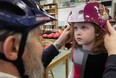 Charles Griffith, a volunteer with the local Brain Injury Association, helps Paige Rosebush, 7, get fitted for a helmet. 
(Windsor Star files)