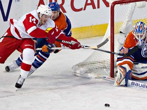 Detroit Red Wings' Gustav Nyquist (14) is stopped by Edmonton Oilers goalie Devan Dubnyk (40) as Ryan Smyth (94) defends during second period NHL hockey action in Edmonton on Friday March 15, 2013. (THE CANADIAN PRESS/Jason Franson)