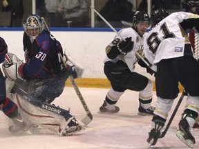 LaSalle's Eric Noal, right, gets the puck past Strathroy's Dalen Kuchmey, left,  for a first period goal as the LaSalle Vipers host the  Strathroy Rockets in Game 3 of of their first-round series at the Vollmer Centre, Sunday, March 3, 2013.   (DAX MELMER/The Windsor Star)