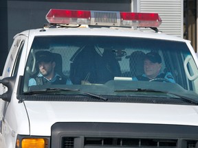 A prison van containing four suspects in a daring helicopter prison break leave the courthouse after being arraigned, Monday, March 18, 2013 in Saint-Jerome, Que. THE CANADIAN PRESS/Ryan Remiorz ORG XMIT: RYR102