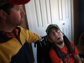 Maurice Chauvin, left, and his son, Joe Chauvin, 17, are pictured at their home in Stoney Point, Monday, March 14, 2013.  Joe Chauvin, who suffers from cerebral palsy, will have his funding cut when he turns 18.  The funding provides Chauvin with a support worker 2 times a week.  (DAX MELMER/The Windsor Star)